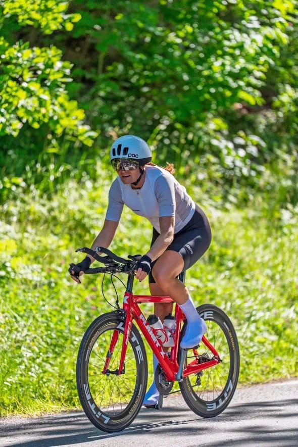 Emma på sin röda tempocykel på en solig landsväg